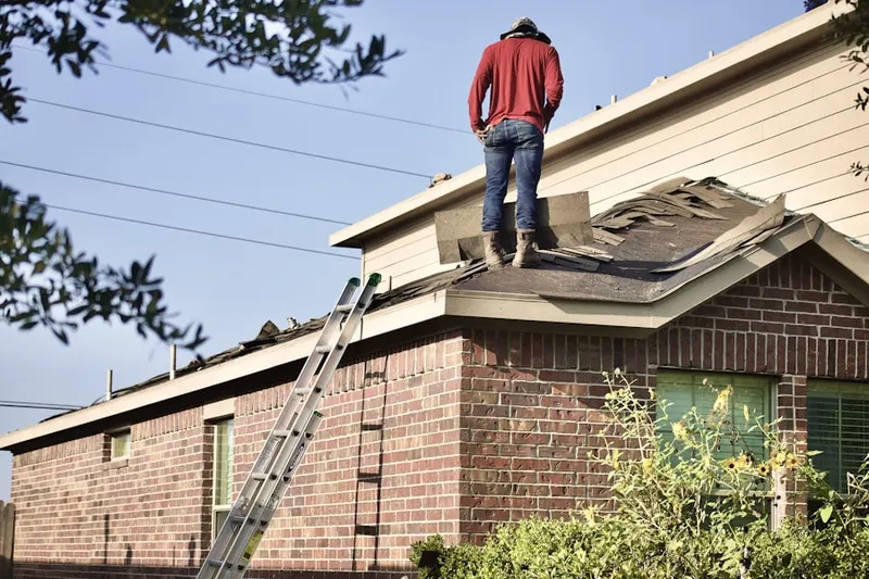 Professional roofer working on a residential roof in Deerfield Parade